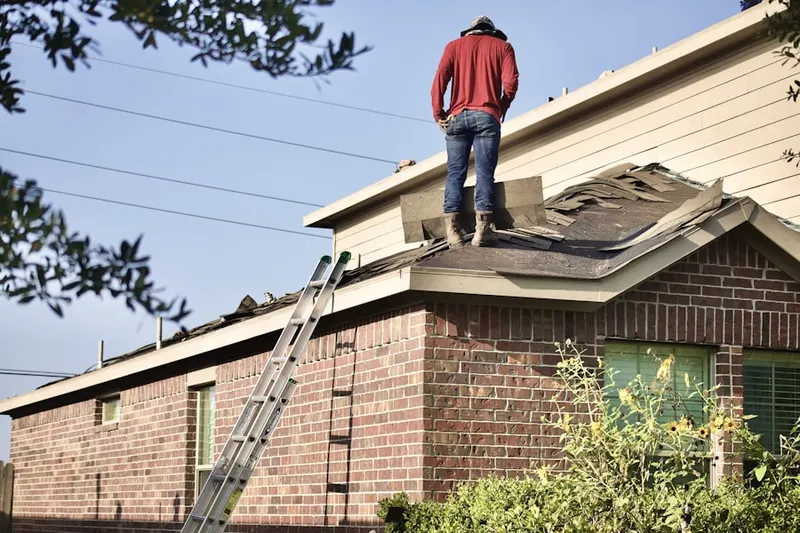 Professional roofer working on a residential roof in Park Central